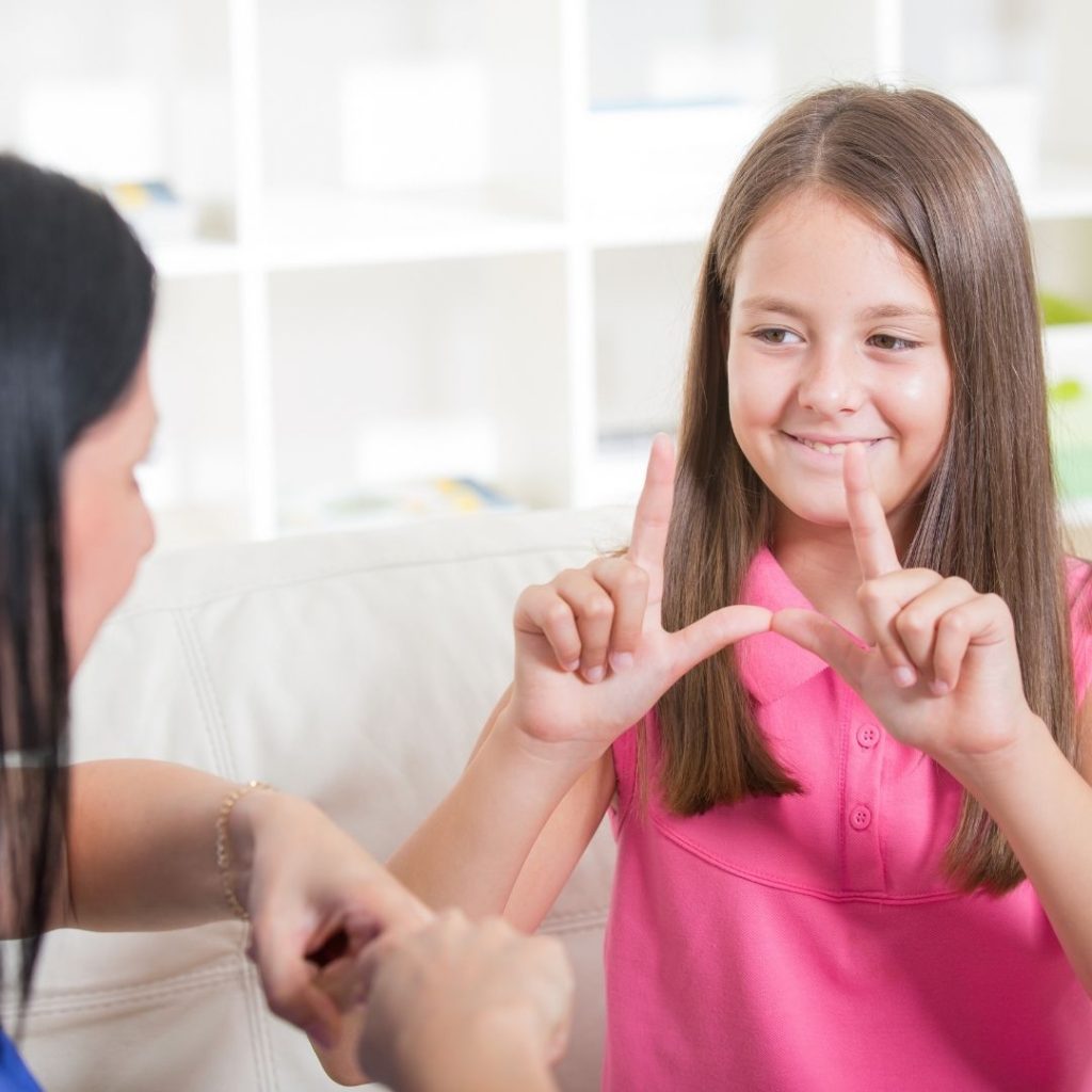 student using sign language in a classroom tp increase student engagement in virtual lessons