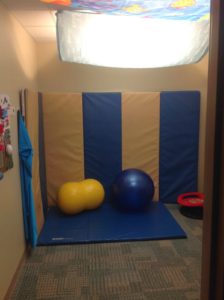 Sensory room for Autism with white and blue foam and lights covered with a sheet