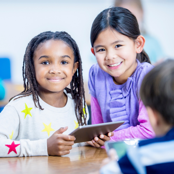 Children engaging with digital devices together.